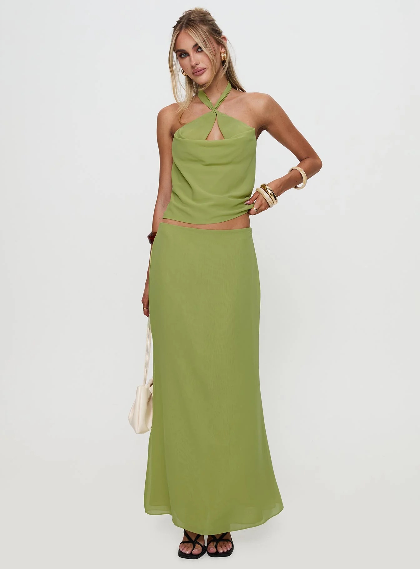 woman wearing green top and green maxi skirt to cocktail & semi-formal spring wedding