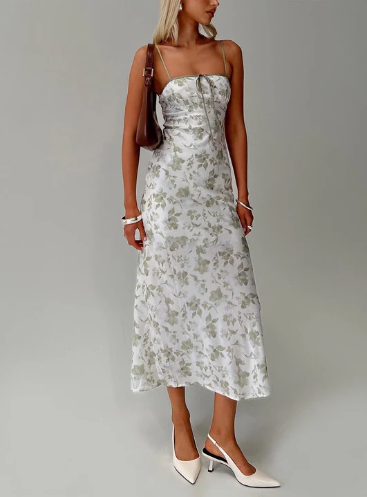 woman wearing white green floral maxi dress to spring garden wedding 