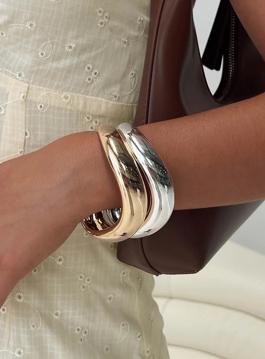 woman wearing silver and gold bangles to spring wedding