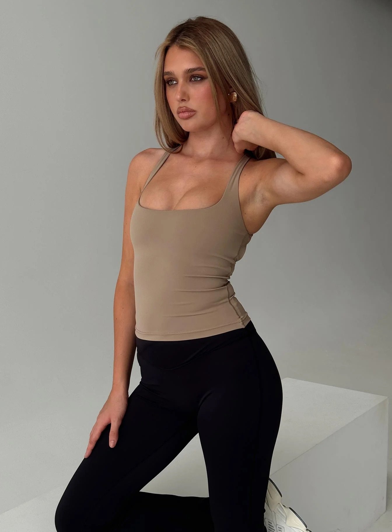 woman wearing taupe cross back activewear top