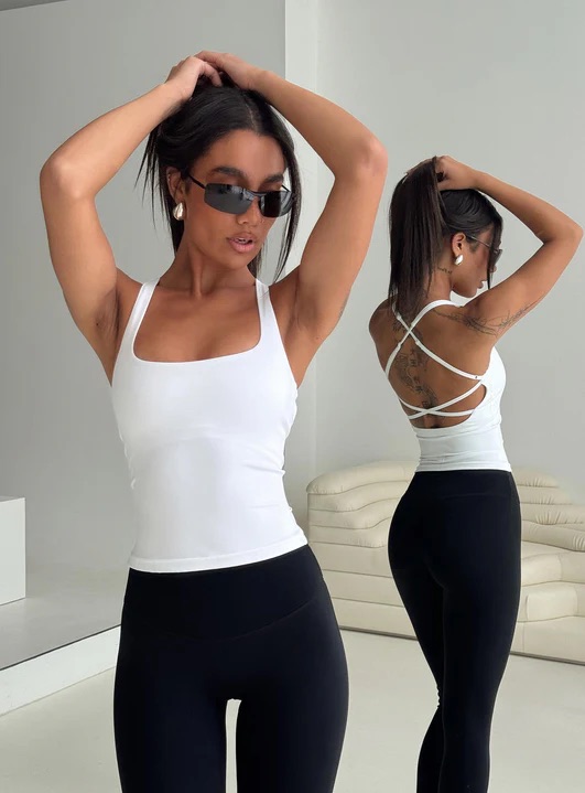 woman wearing white cross back activewear top