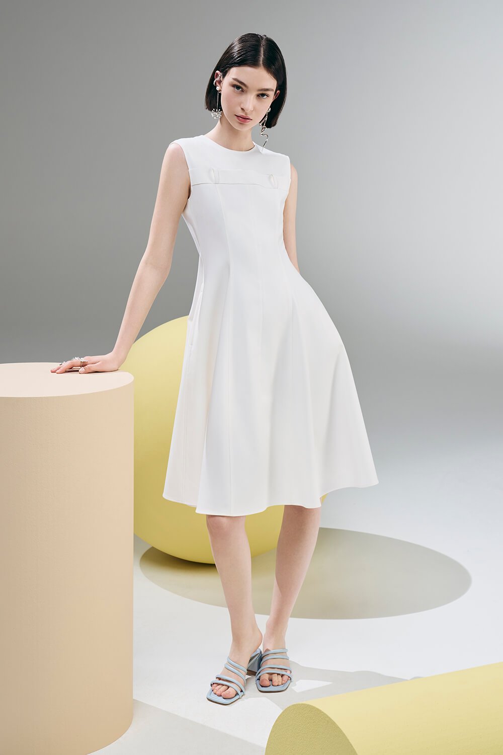 Model wears a white midi dress