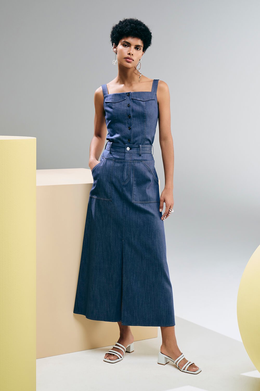 Model wears a long skirt with a navy top