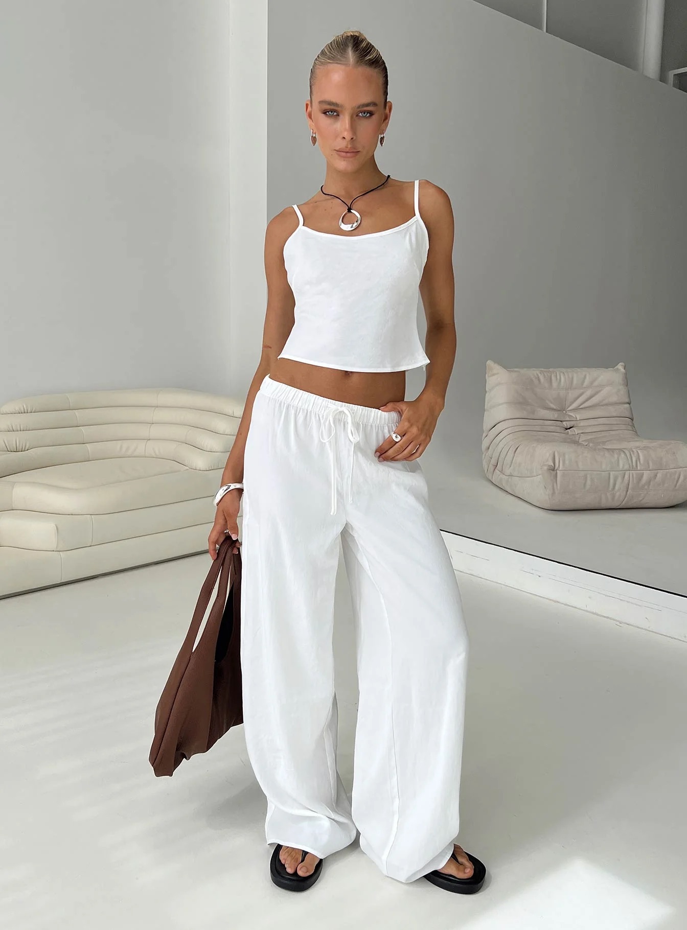 woman wearing white lounge set to work from home