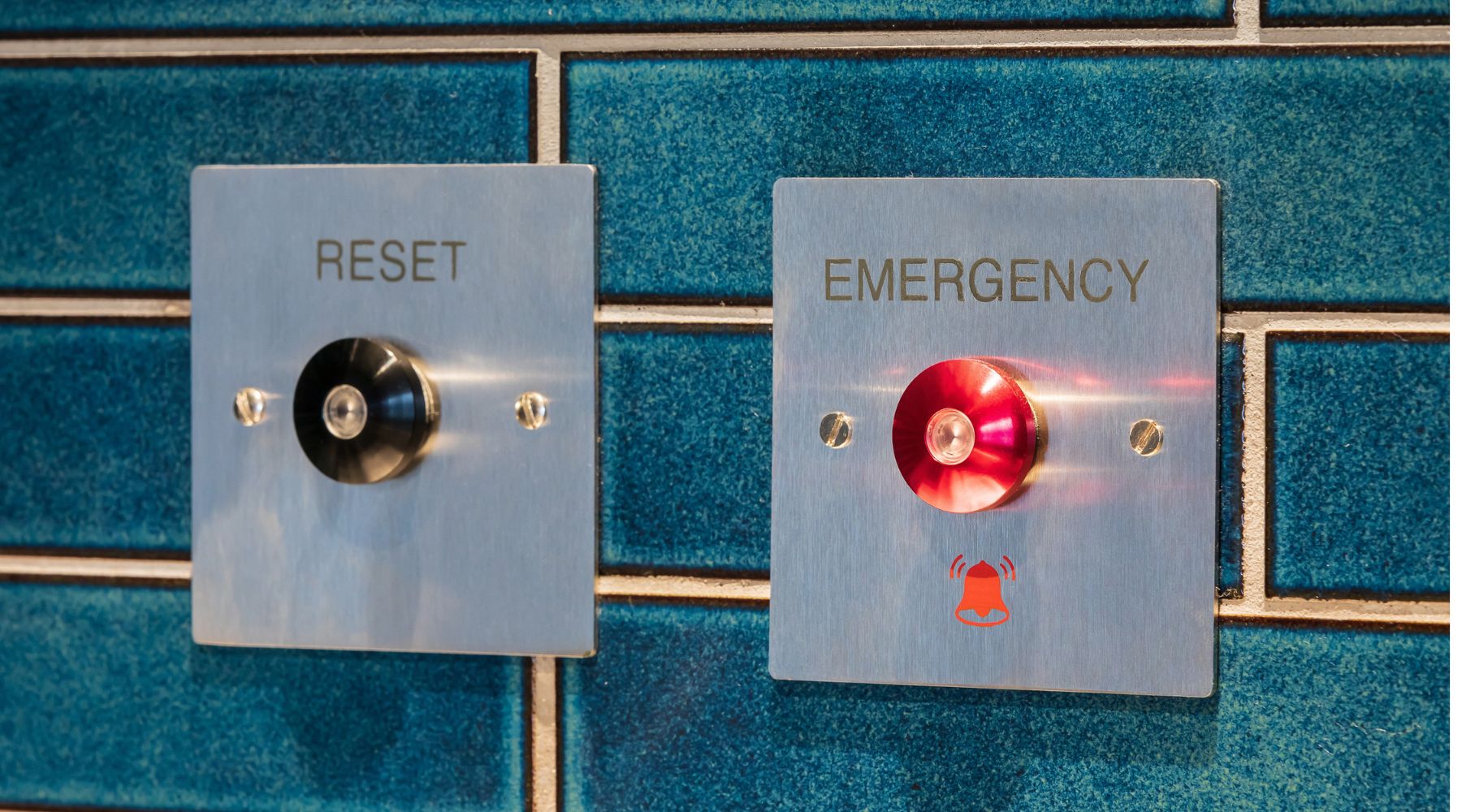 Emergency push button alarms against stylish blue tiles