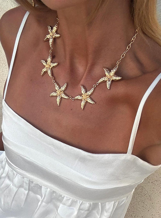 woman wearing starfish necklace for summer