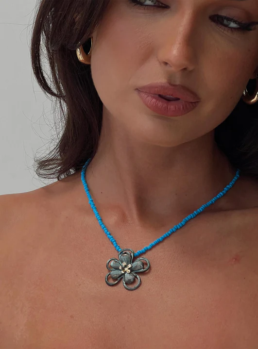 woman wearing blue necklace for summer