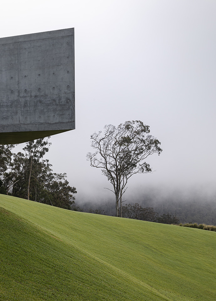Even in the fog, the sculptural concrete cantilever defines the house both visually and pragmatically. Photo © Cam Murchison.