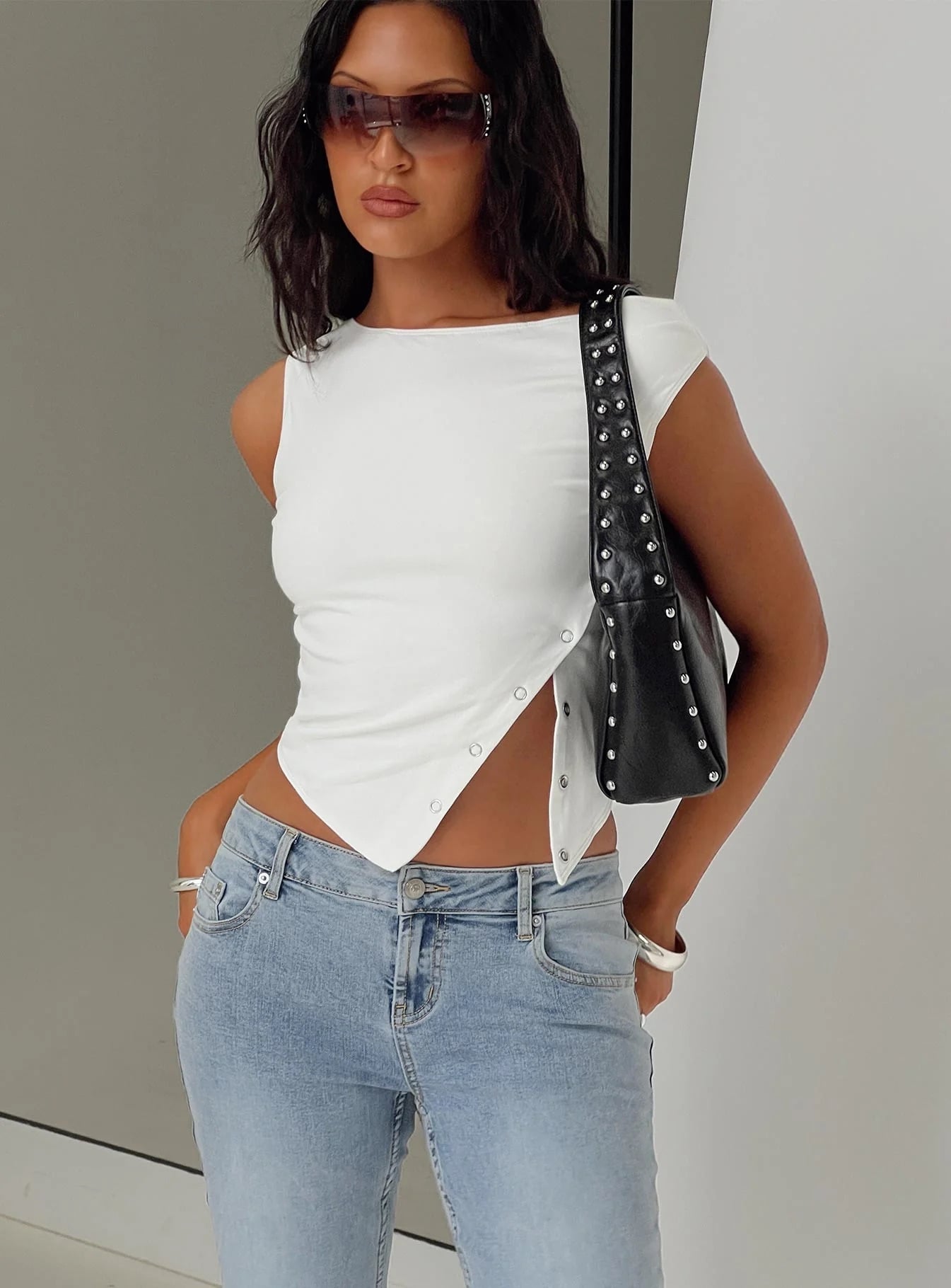 woman wearing white top with wide leg jeans