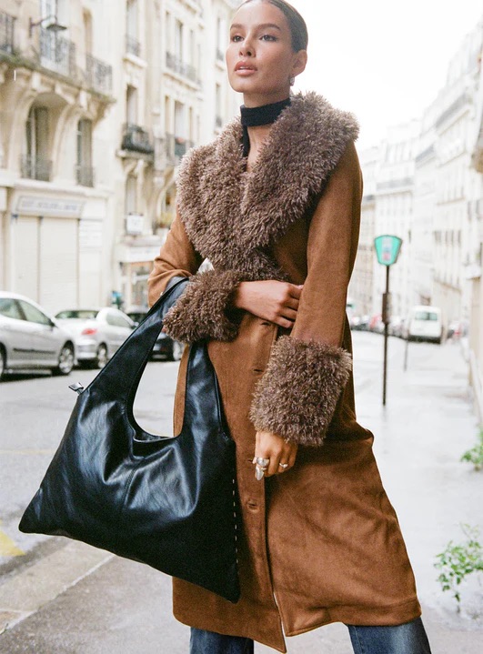 woman wearing shearling brown jacket with wide leg jeans