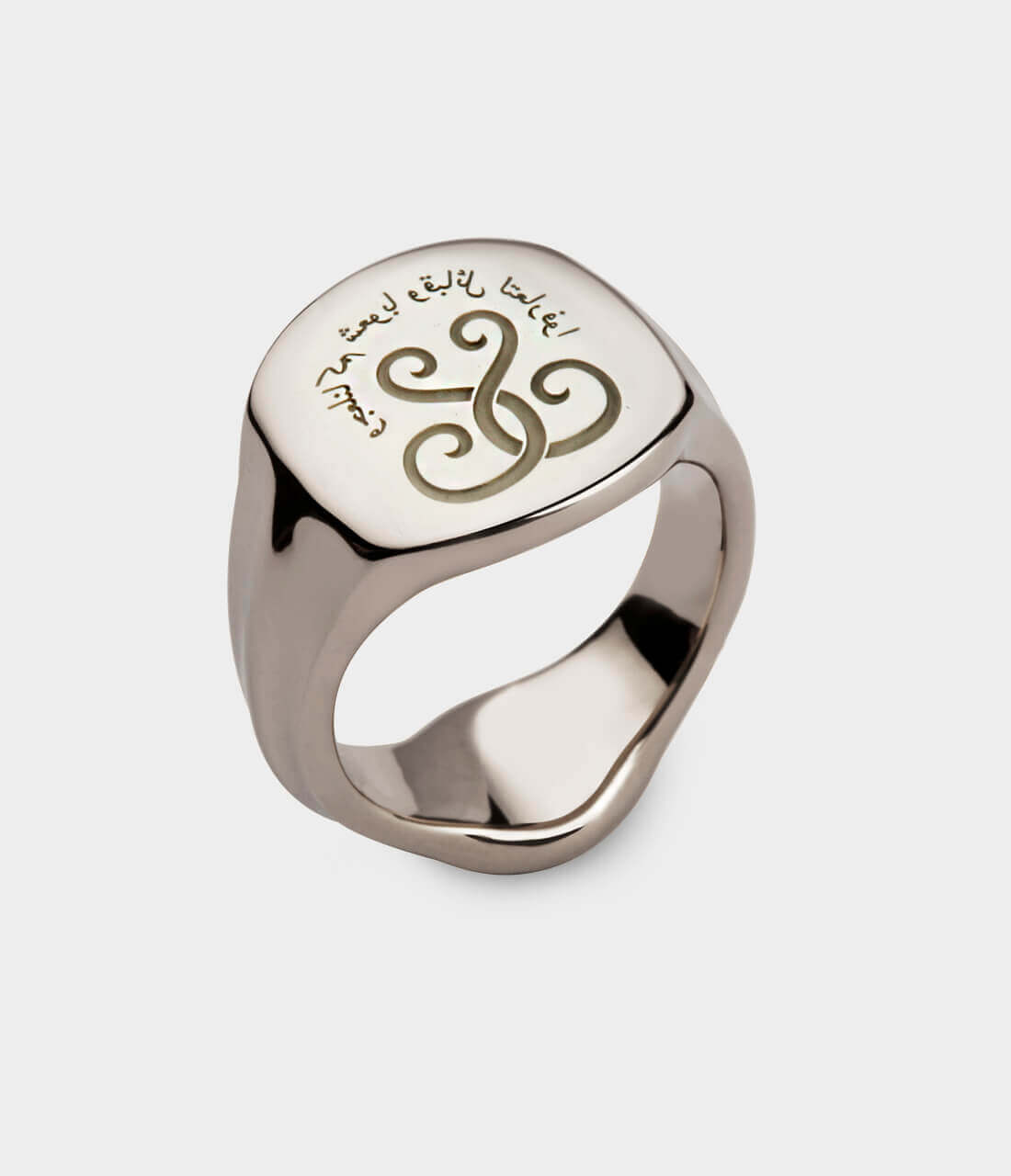 A white gold signet ring with Arabic letters engraved on it