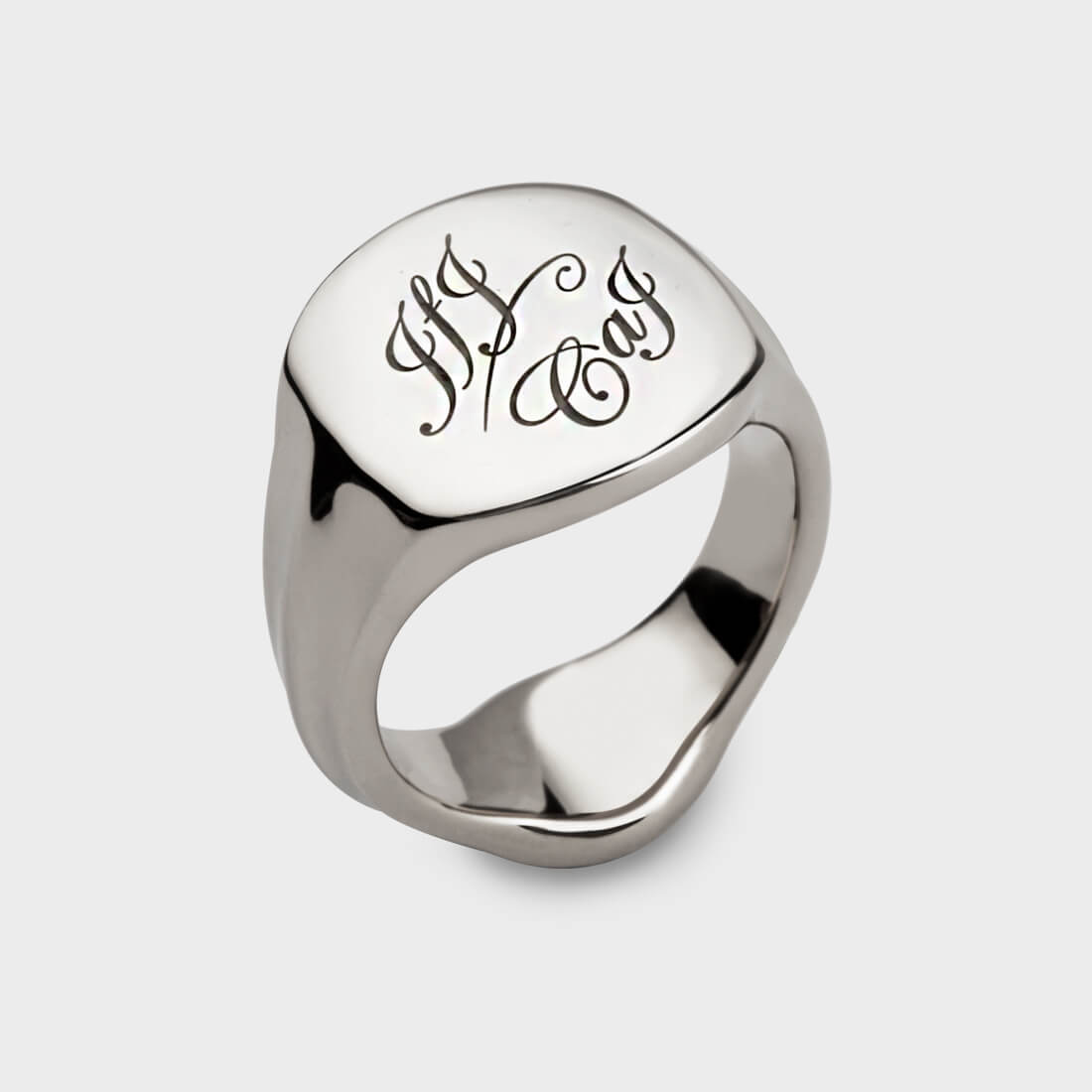 A sterling silver signet ring with interlocking letters on it