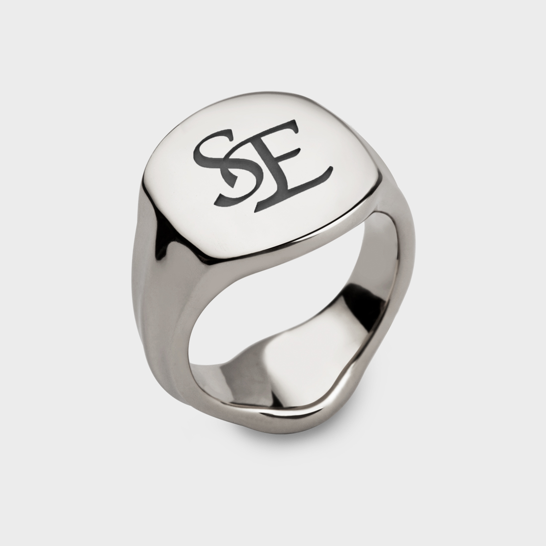 A sterling silver signet ring with two interlocking letters S and E engraved on it