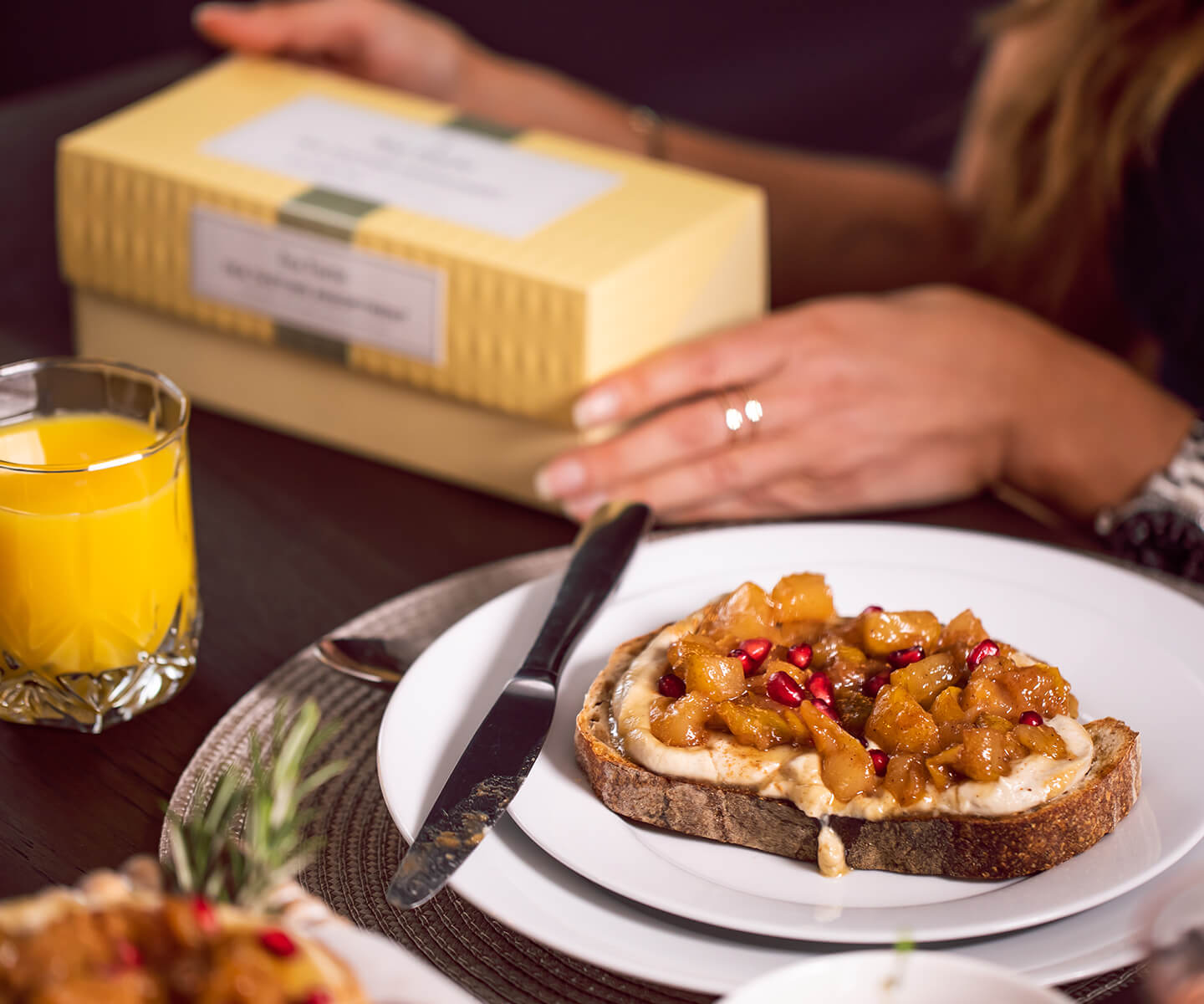 A slice of Vanilla Pear Toast with a box of tea in the background