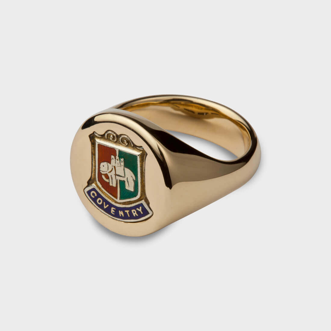 Yellow gold oval signet ring with coventry enamel design in blue green and red colours