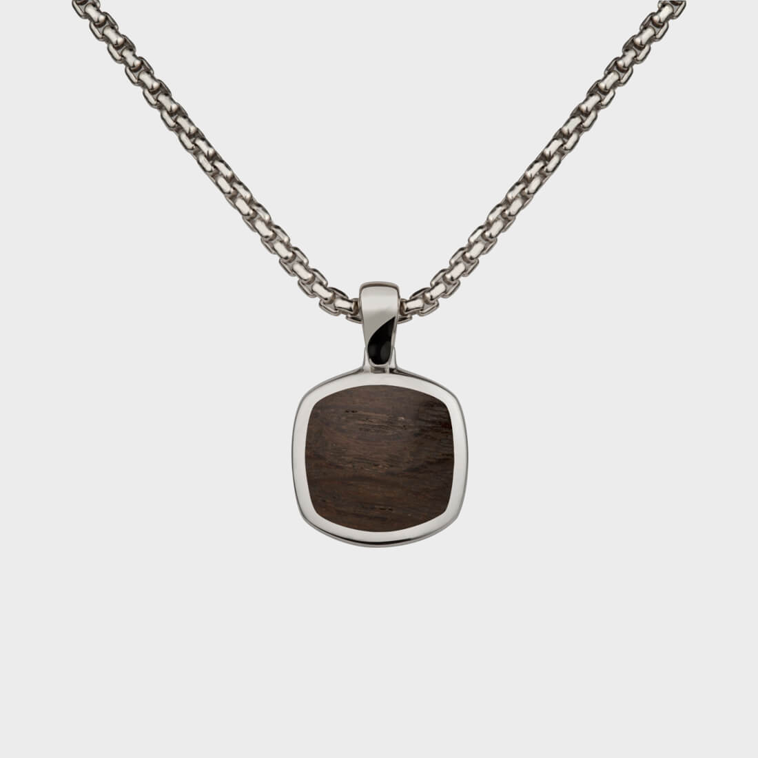 A sterling silver signet pendant inlaid with Thames wood