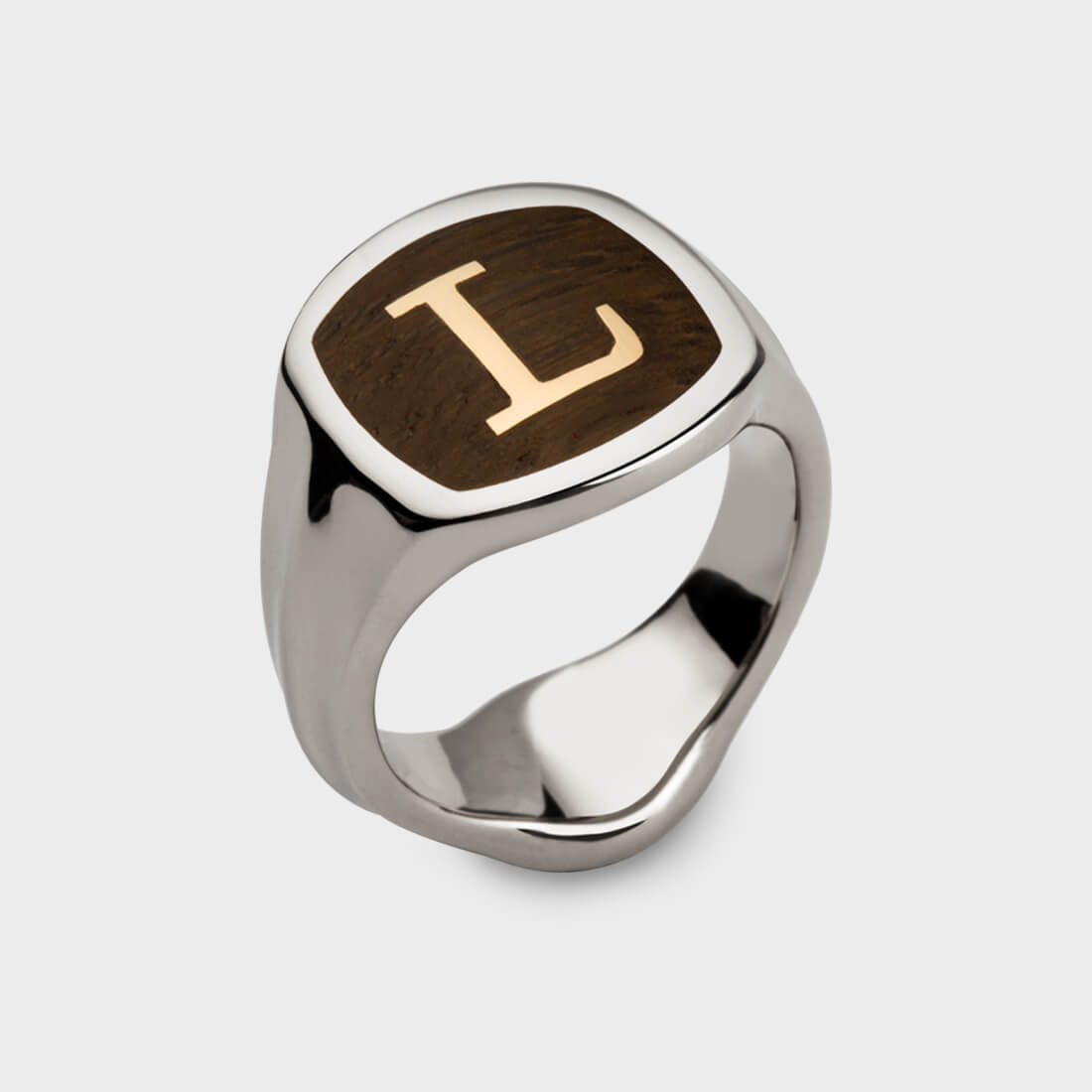 A sterling silver signet ring inlaid with Thames wood and the letter 'L' engraved in yellow gold in the middle of the wood. 