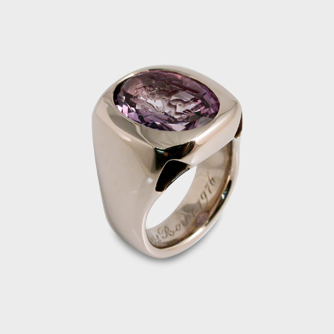 A white gold signet ring with an intaglio technique amethyst stone