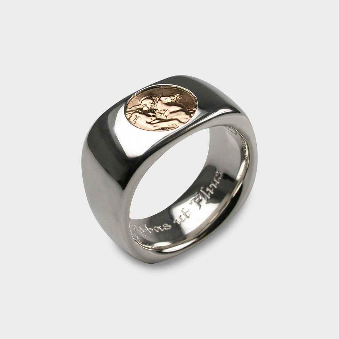 A silver ring with an ancient coin in bronze set in it