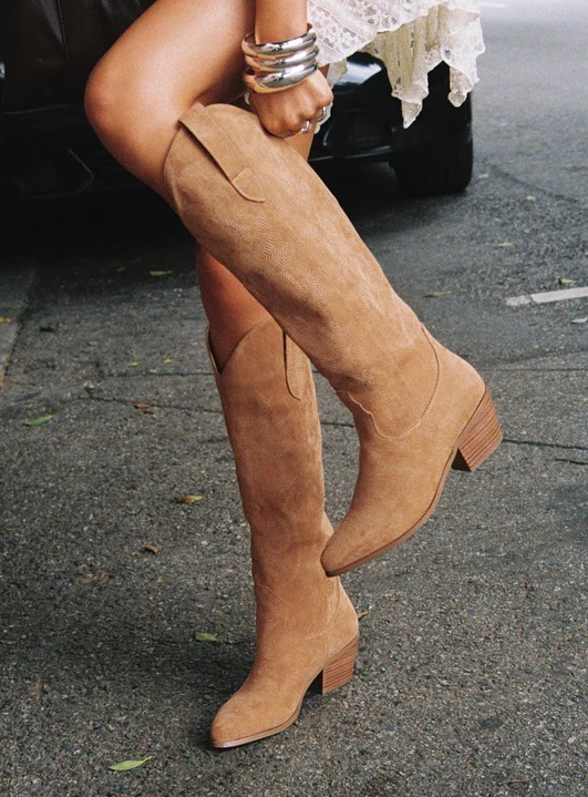 woman wearing tan cowgirl boots 2025