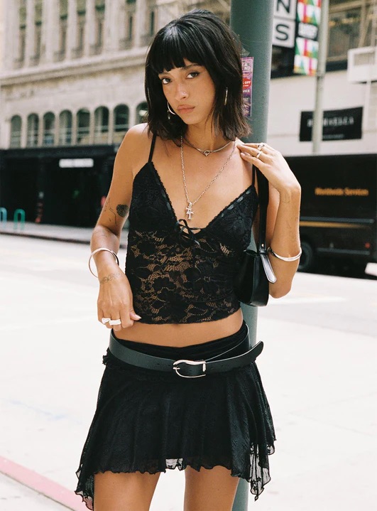 woman wearing black lace mini skirt with cowgirl boots
