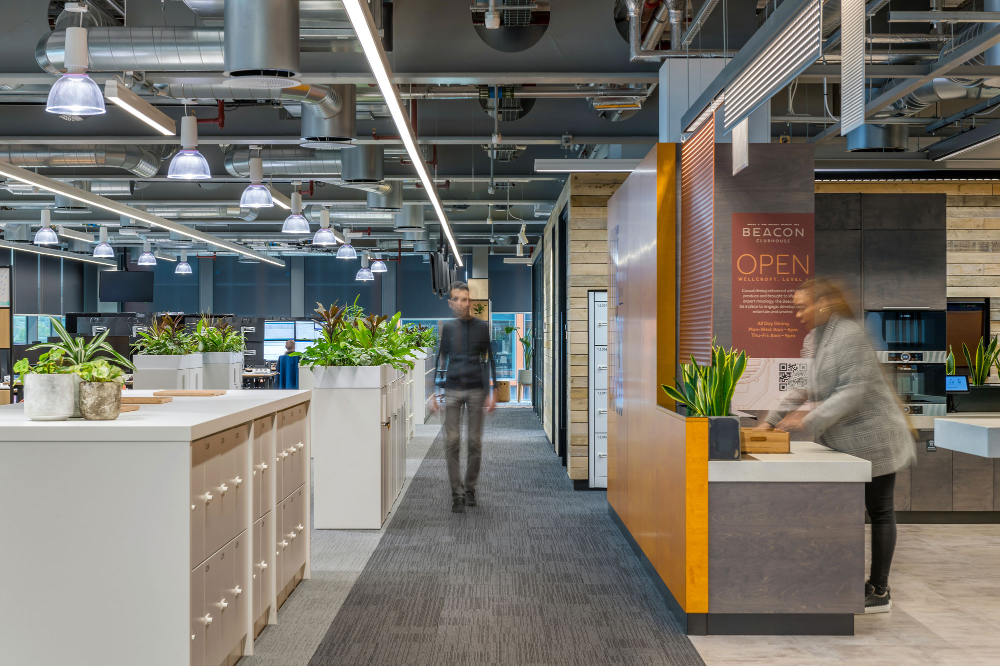 Barclays' open plan office with clear zoning, including a kitchenette area with lowered worksurfaces