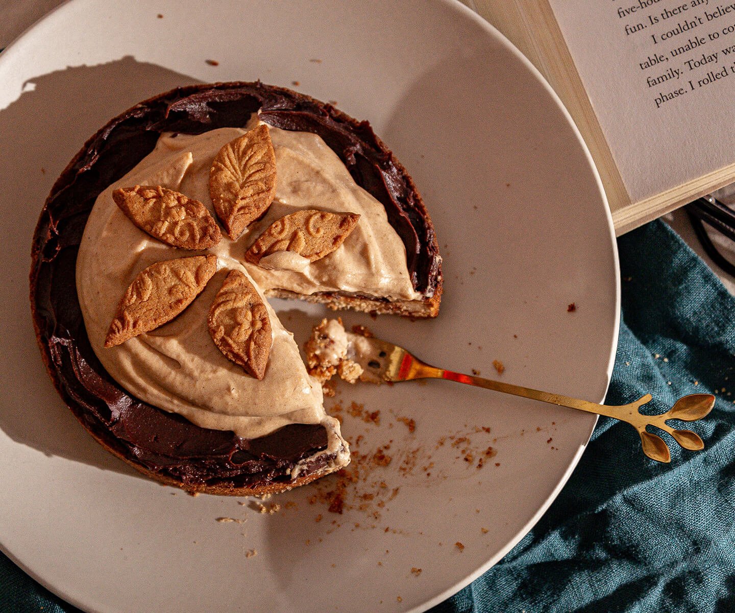 Partially eaten Black Bottom Sablé Breton Tart with Harvest Apple Spice Mousse on a plate with a fork