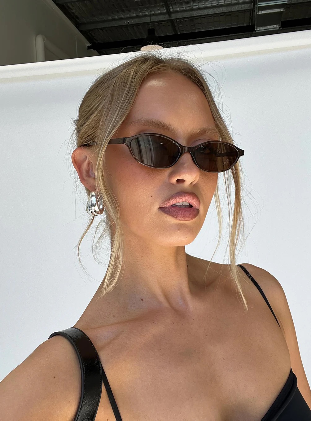 woman wearing a Princess Polly Cool Girl sunglasses