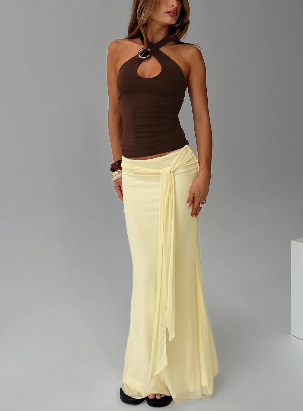 woman wearing princess polly yellow maxi skirt