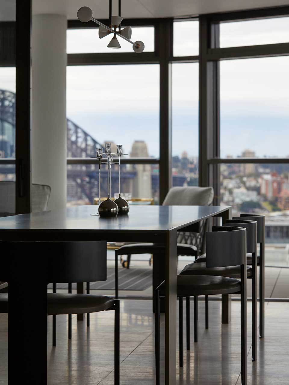 Overlooking the Sydney Opera House, the apartment features the Metallico dining table by Living Divani and Baxter Zefir chairs.