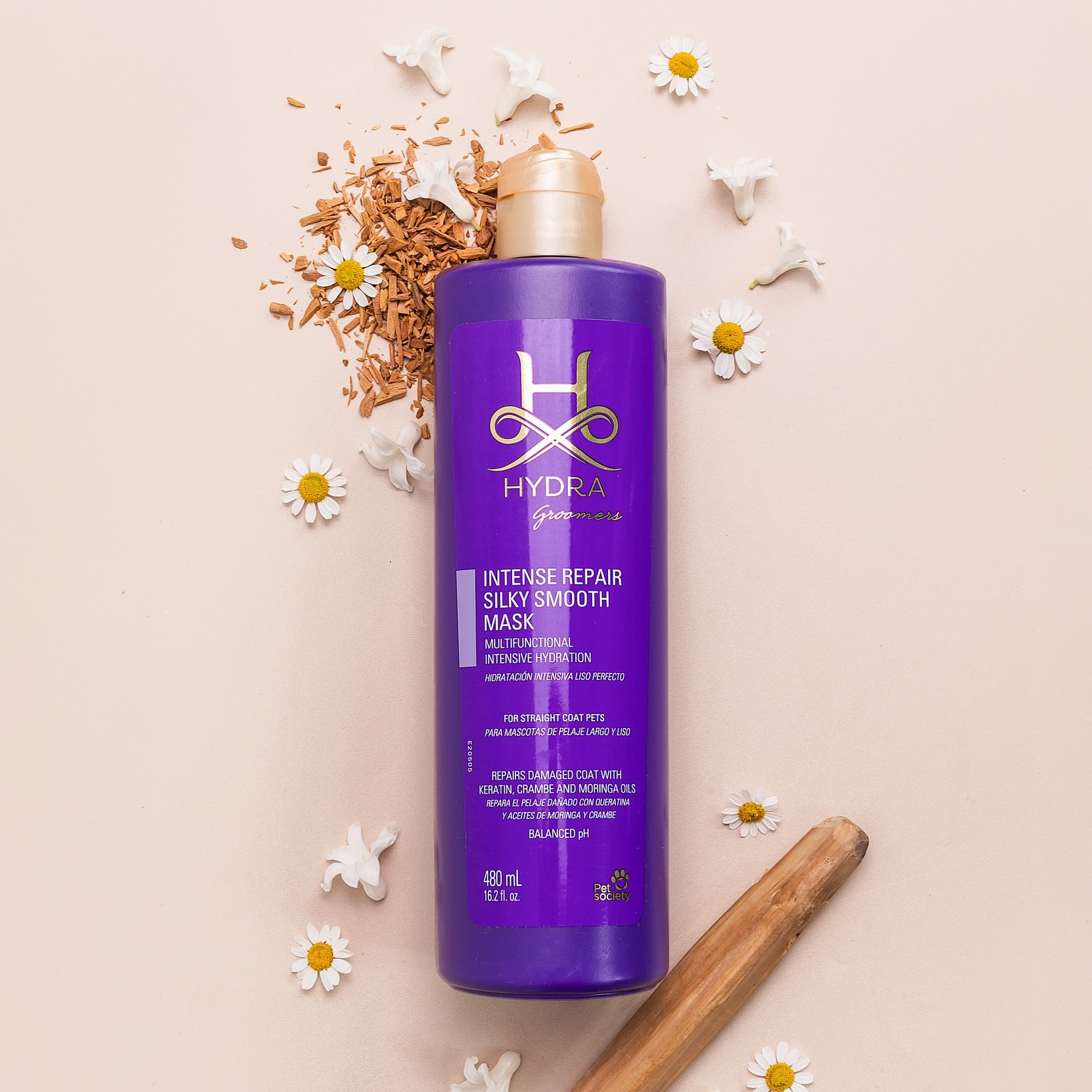 Purple bottle of professional dog conditioner with chamomile flowers and sandalwood.