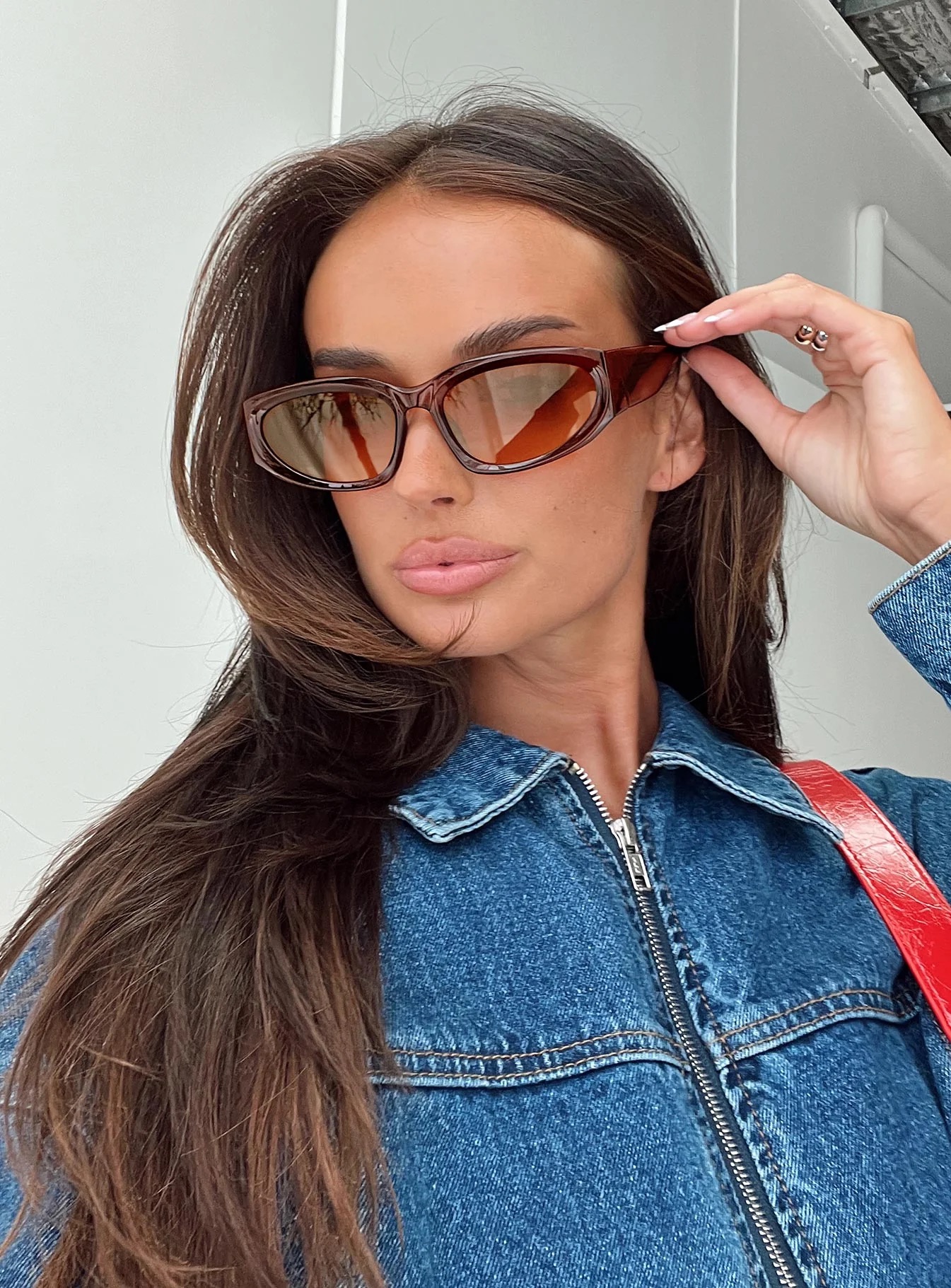 college student wearing brown sunglasses to football game