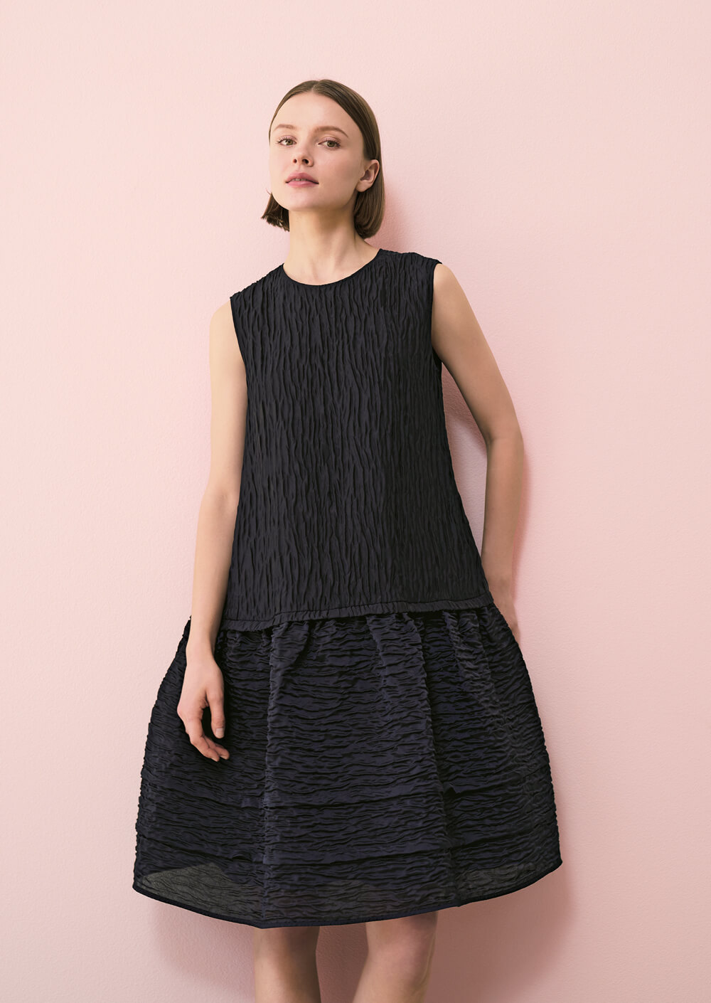 Model wears a black dress