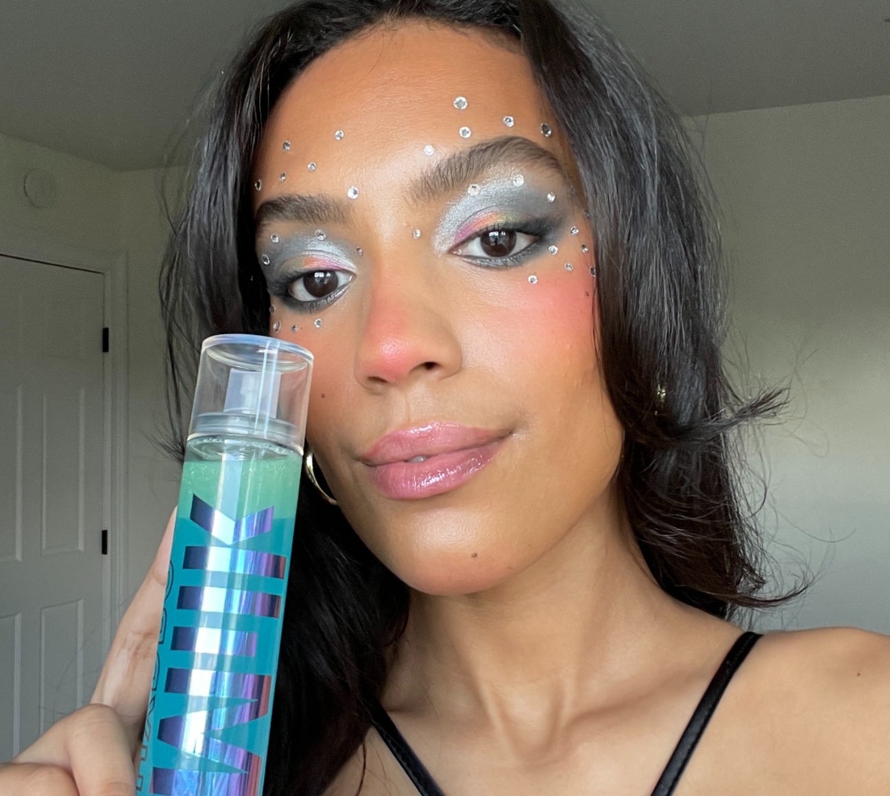 Lexus Perez wears Milk Makeup Hydro Grip Eye Primer and colorful makeup with rhinestones.