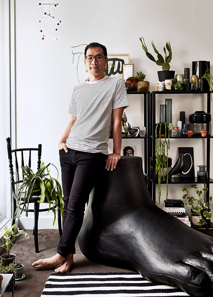 Stylist Hallam Choy in his Sydney apartment with the UP Series 2000 UP7 Foot, and the Extension chair designed by Sjoerd Vroonland for Moooi. Photo c/o Space.