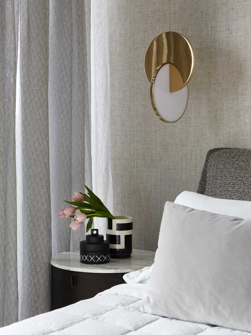 The Lee Broom Eclipse pendant light adds further lustre to the bed and Poliform Onda bedside table.