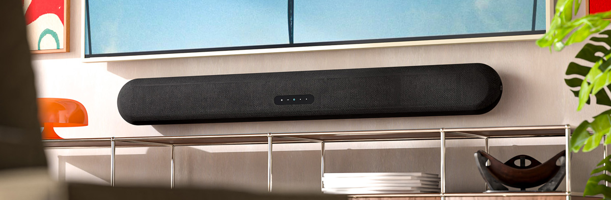 Bluesound Pulse Cinema Soundbar mounted on a wall under a television