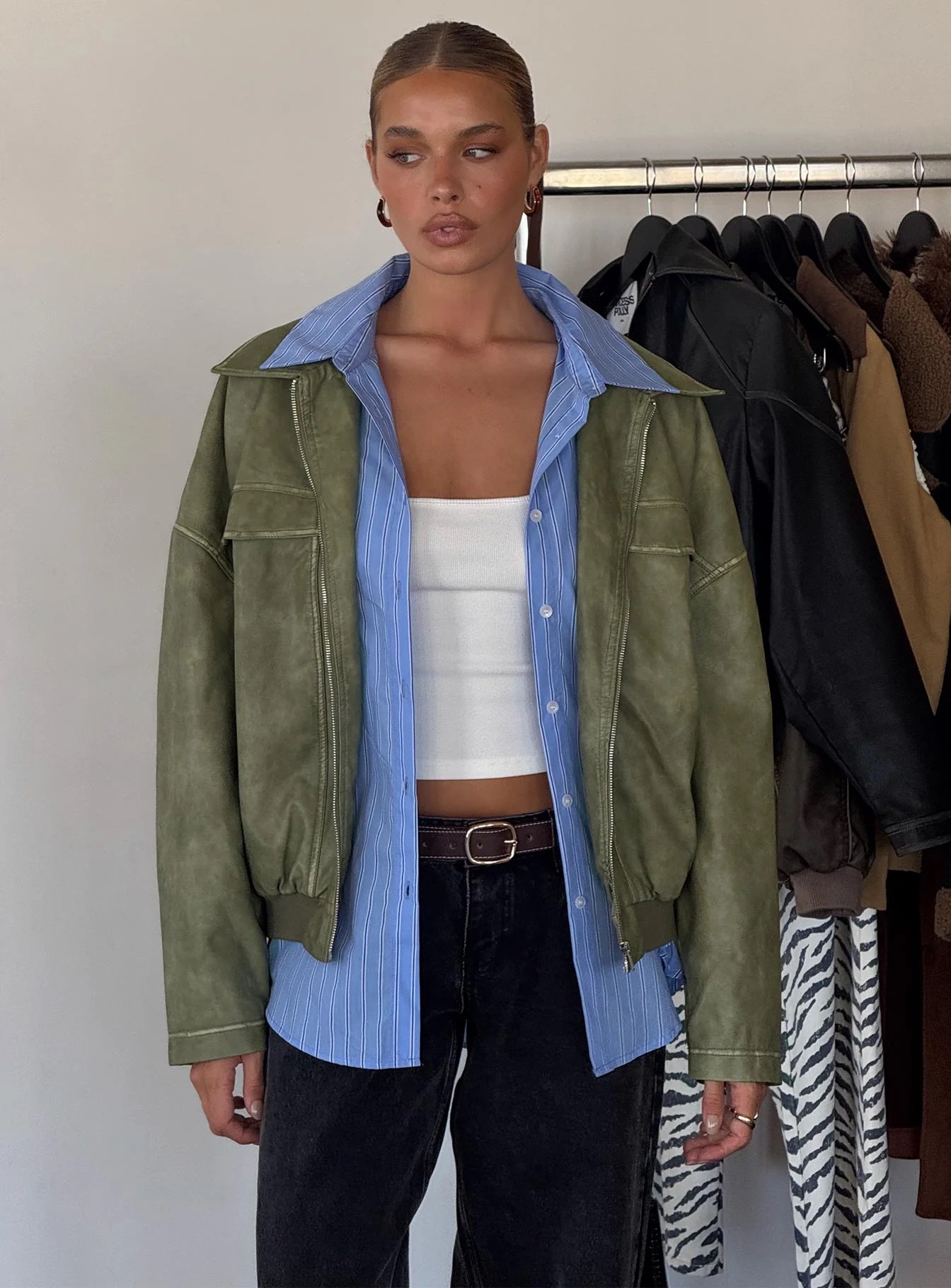 woman wearing princess polly blue button up shirt under a jacket