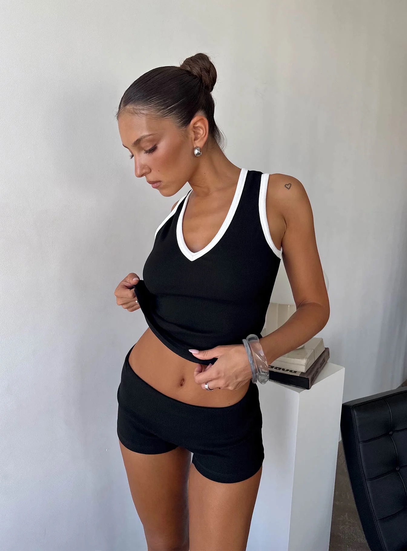 woman wearing princess polly black shorts