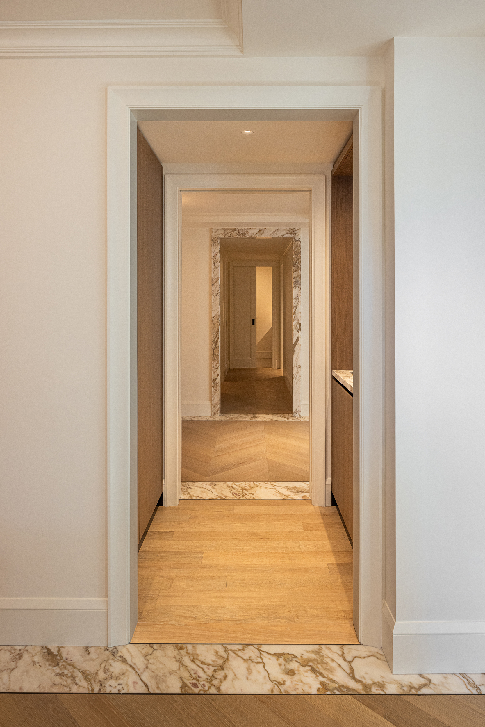 A hallway with PID Floors warm-tone hardwood flooring at The Surrey Residences NYC