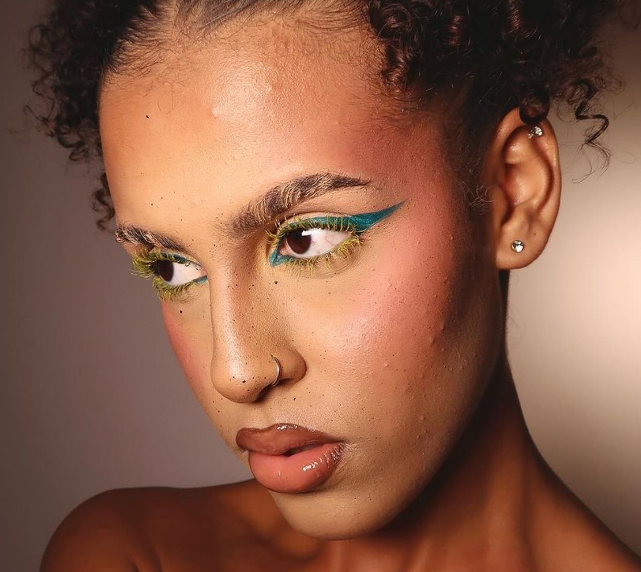 Model wears a colorful makeup look for holiday makeup inspiration