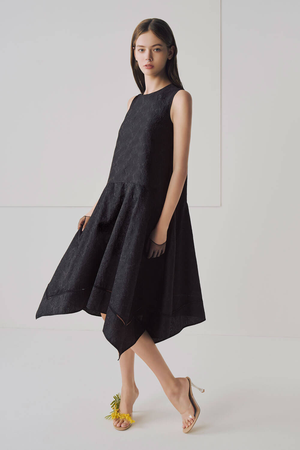 Model is wearing a black dress. 