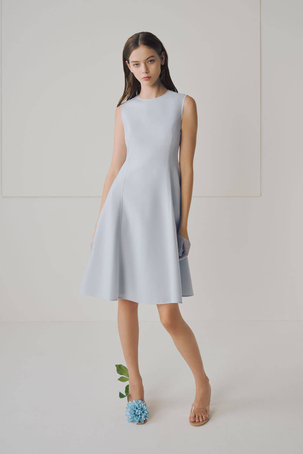 Model is wearing a baby blue dress. 