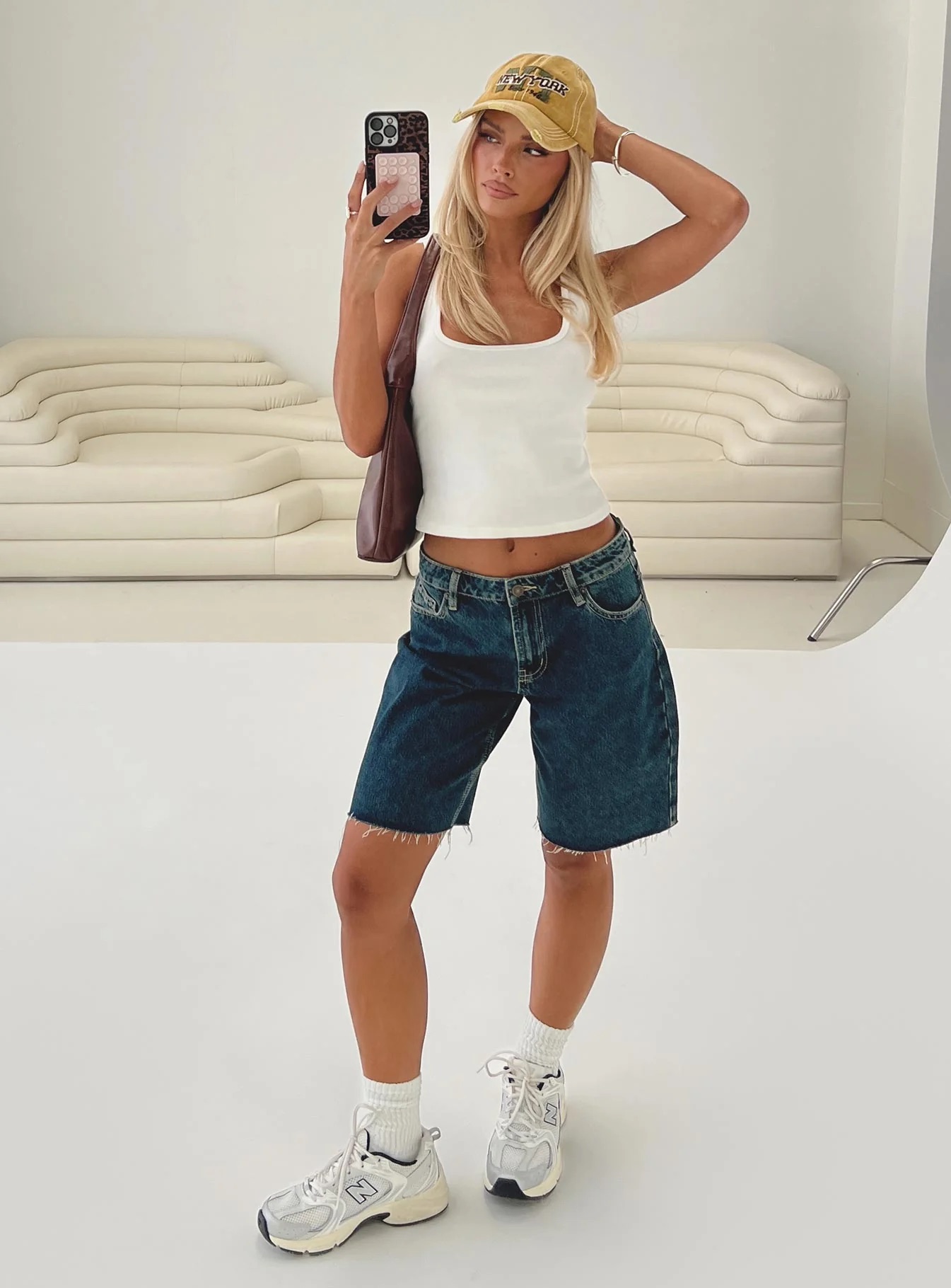 woman wearing princess polly longline denim shorts to baseball game