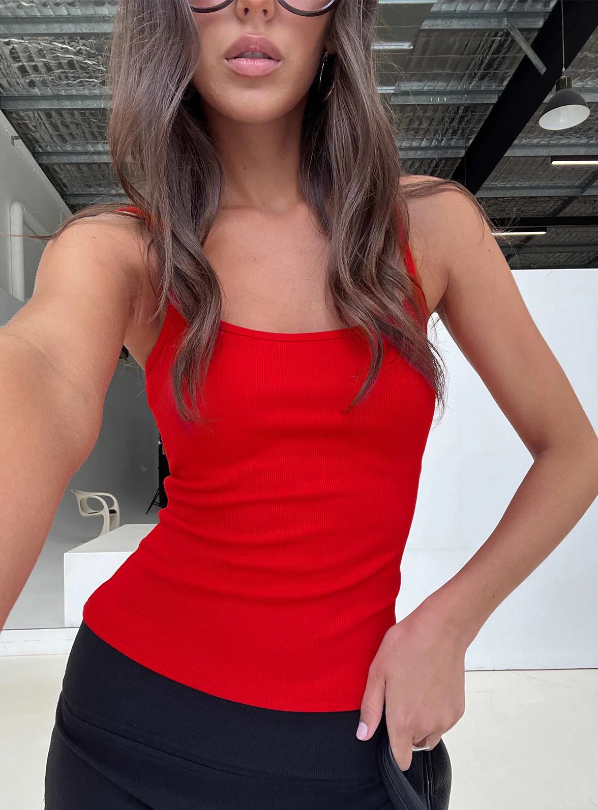 woman wearing princess polly red longline tank top to summer baseball game