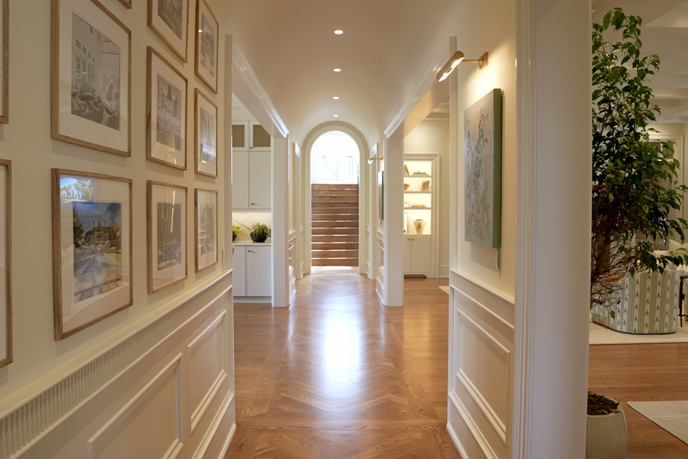 Hallway in a large home with in-ceiling lighting