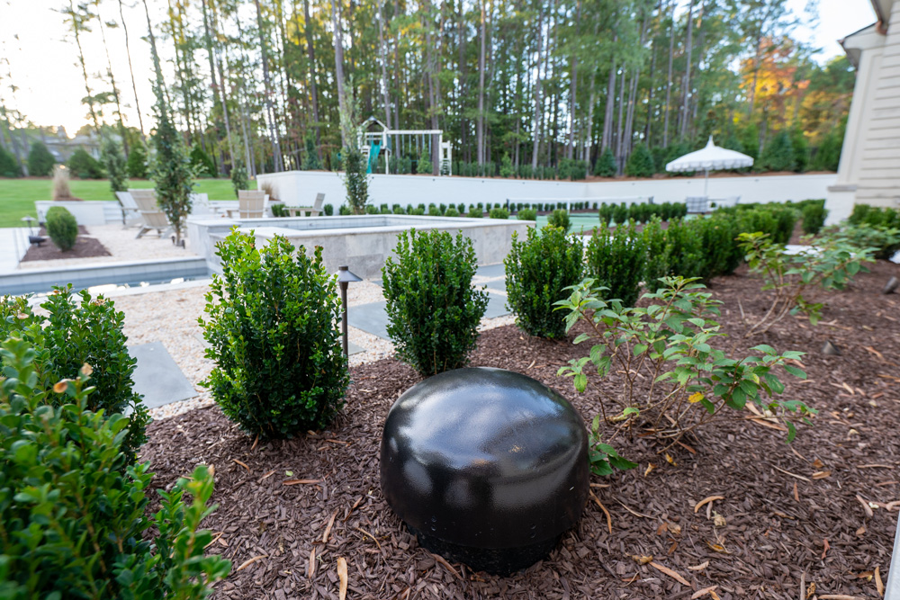 Outdoor speaker behind bushes