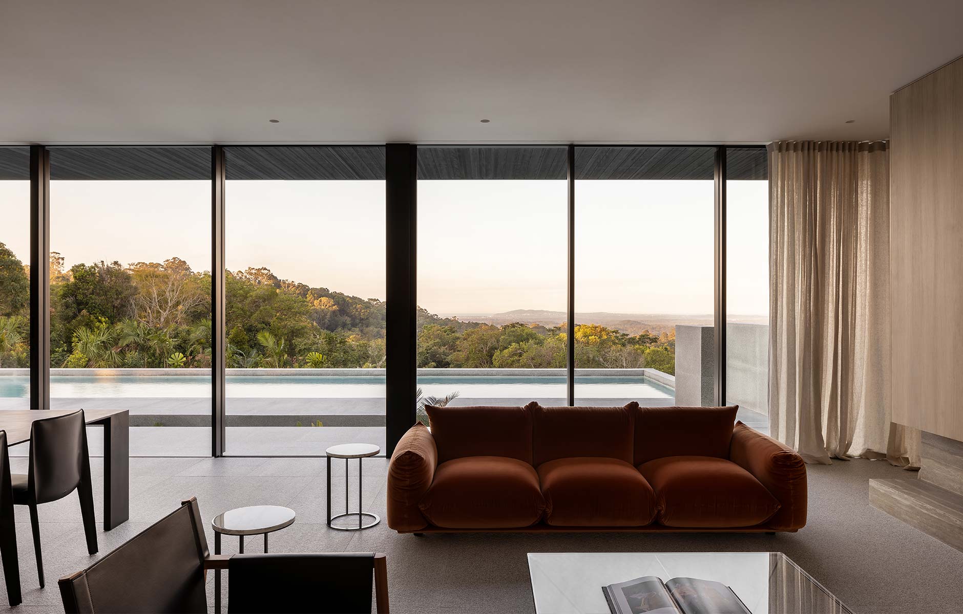 The Marenco Sofa by Arflex in an earthy rust velvet that balances with the surrounding landscape. Photo © Timothy Kaye