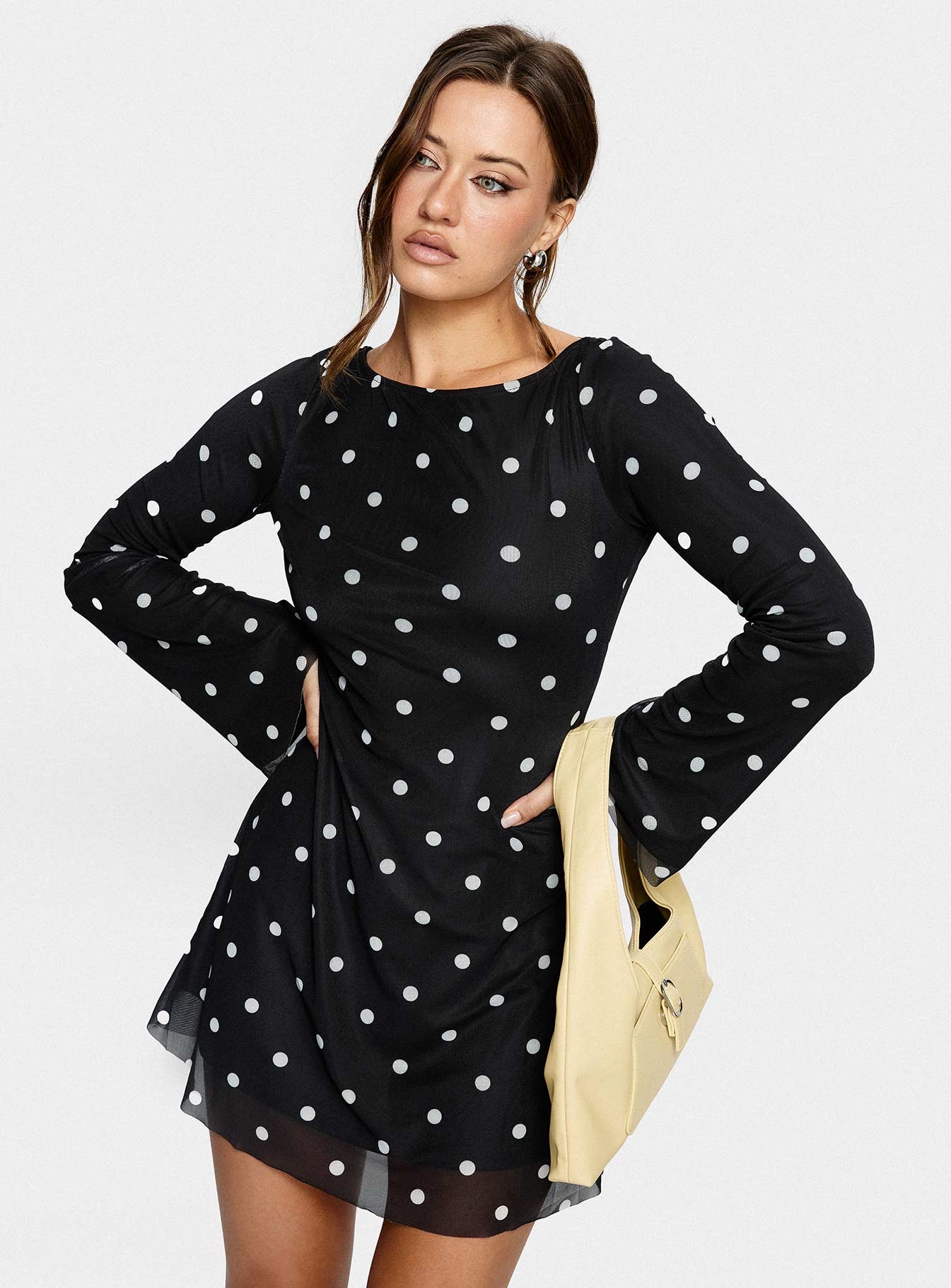 woman wearing a polka dot long sleeve mini dress for winter date night