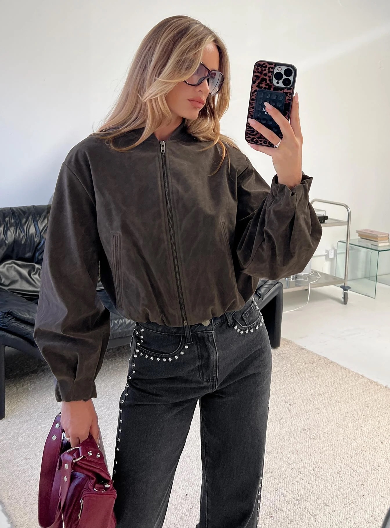 woman wearing faux suede bomber jacket for winter date night